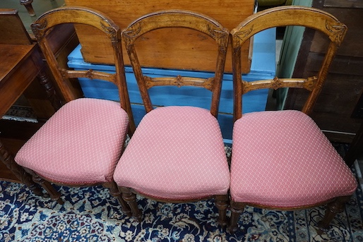 A late Victorian mahogany oval topped occasional table, width 75cm, height 71cm together with three Victorian oak dining chairs